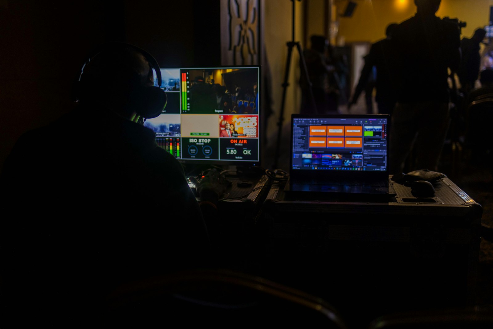 A person working at a laptop in a production space